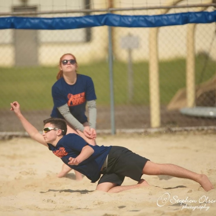 Sophomore Brady Plucker plays a game of sand volleyball